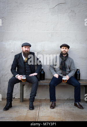 Deux hommes assis à boire de la bière. Banque D'Images