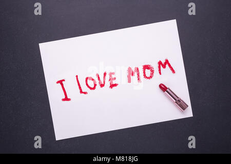 J'aime maman écrit par le rouge à lèvres rouge en papier blanc sur fond noir en noir Banque D'Images