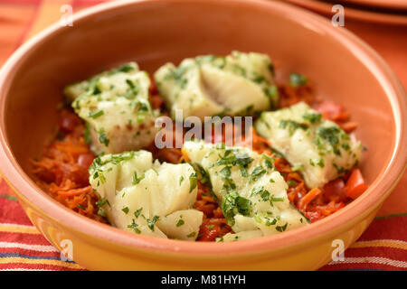 Morue au four sur lit de légumes dans un plat allant au four Banque D'Images