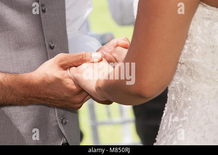 Une femme et un homme tenir la main pendant la cérémonie de mariage. Banque D'Images