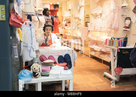 L'homme japonais avec une machine à coudre dans un magasin de vêtements faits à la main à Tokyo, Japon Banque D'Images