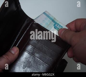 Une personne se retire de la bourse bill valeur faciale de mille roubles russes. Close up. Banque D'Images