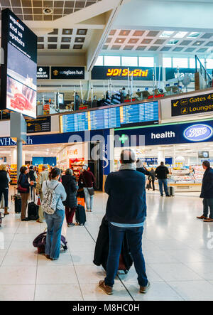 Londres Gatwick, 15 mars 2018 : Les passagers de vérifier leurs informations de vol sur un affichage numérique au Terminal Nord de Gatwick de Londres Banque D'Images