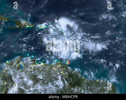 Des pays caraïbes en rouge sur la planète Terre avec des nuages dans la nuit. 3D illustration. Éléments de cette image fournie par la NASA. Banque D'Images