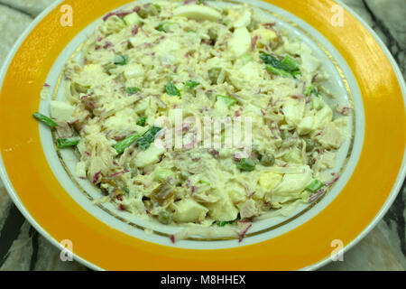 Salade de printemps frais fait maison avec la roquette, radis avec l'oignon rouge et avocat aux oeufs dans un bol blanc sur fond d'hiver tableau sain végétarien. Banque D'Images