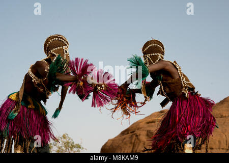 Deux hommes masqués Dogon autochtones en costumes traditionnels qui prennent part à une danse traditionnelle. Le Mali, Afrique de l'Ouest. Banque D'Images