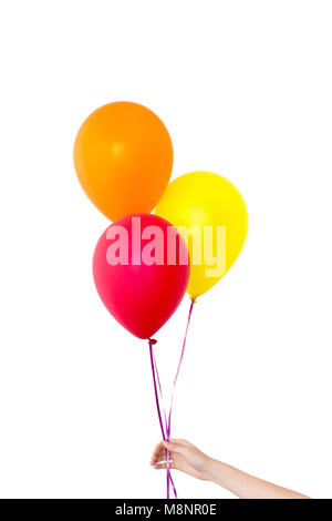 La main de femme détient des ballons dans un fond blanc Banque D'Images