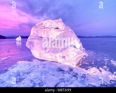 Couper la glace. Cubes écrasés éclairée avec rétroéclairage puissant. Silent Bay avec télévision niveau congelé. Le spectre de la lumière dans la glace. Banque D'Images