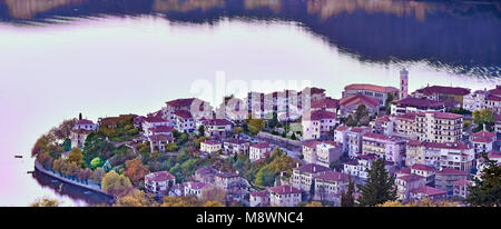 Vue panoramique de la ville de Kastoria reflétée sur la surface du lac Orestiada paisible aux couleurs de l'automne, à l'ouest de la Macédoine, la Grèce du Nord Banque D'Images