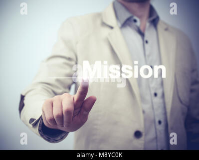 Homme d'affaires est l'appui sur le bouton sur l'interface de l'écran tactile et la sélection de mission Banque D'Images