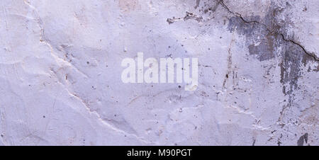Sécheresse fissuré vieux mur de plâtre gris et blanc arrière-plan de texture Banque D'Images