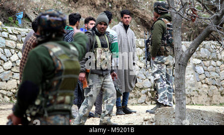 Srinagar, au Cachemire. Mar 21, 2018.Armée indienne monte la garde comme peuple cachemiri à regarder, au cours d'une fusillade entre le gouvernement et les militants à Halmatpora Kupwara, quelque 95 km (60 milles) au nord de Srinagar.Quatre soldats indiens et quatre militants présumés ont été tués dans un gunbattle près de la frontière de fait entre l'Inde et le Pakistan dans la région contestée du Cachemire le mercredi, un haut responsable de la police a dit.©Sofi Suhail/Alamy Live News Banque D'Images