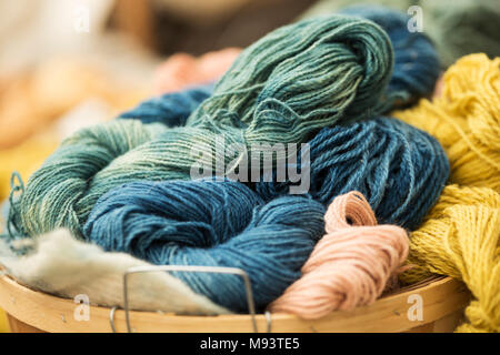 Un panier de laine teint à la main de fils d'artisan à vendre à un marché agricole. Banque D'Images