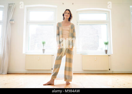 Portrait of smiling mature woman standing in empty room Banque D'Images