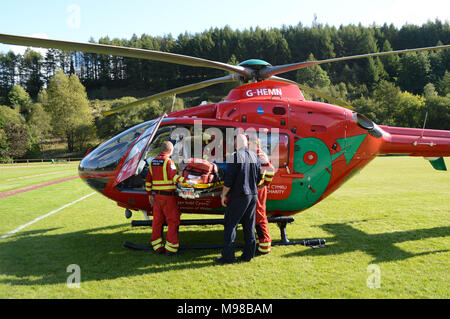 Les membres de l'équipage se tenant debout à l'extérieur un Airbus hélicoptère de la Galles Air Ambulance Service Banque D'Images