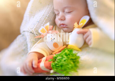 Joyeuses pâques, portrait d'un mignon petit bébé dormir à la maison avec ses jouets, oeufs de Pâques décorés lapins, calme jolie sieste enfant Banque D'Images