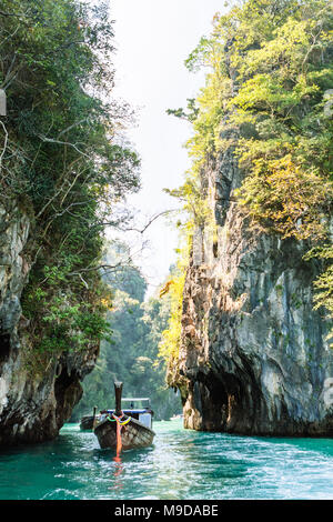 Bateaux Longtail dans la belle mer entre deux gros rochers. La Thaïlande. Banque D'Images