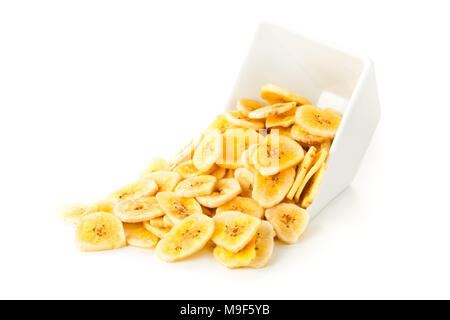 Tas de chips de banane séchée snack dans bol blanc sur fond blanc Banque D'Images