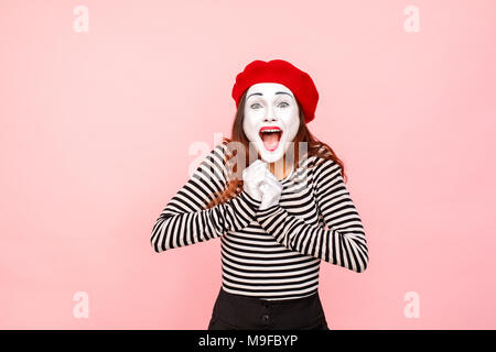 Portrait de femme crier de bonheur et de sourire à pleines dents. Clown, artiste , mime. Fond rose, Studio shot Banque D'Images