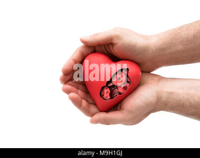 Coeur mécanique rouge en mains isolated on white with clipping path Banque D'Images