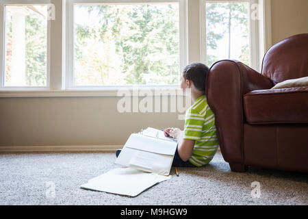 Jeune garçon à la maison à faire leurs devoirs. Banque D'Images