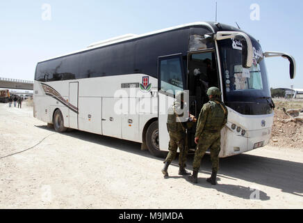 Damas, Syrie. Mar 26, 2018. Les soldats russes superviser l'évacuation des rebelles et leurs familles à un point de rencontre à la périphérie de la ville de Arbeen dans la capitale Damas' l'Est de Ghouta, la Syrie, le 26 mars 2018. Plus de 13 000 rebelles et leurs familles ont évacué les villes centrales dans la capitale syrienne Damas' l'Est de Ghouta campagne au cours des trois jours. Credit : Ammar Safarjalani/Xinhua/Alamy Live News Banque D'Images