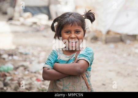 Happy little girl dans le bidonville au dépotoir de Ghazipur, New Delhi, Inde Banque D'Images