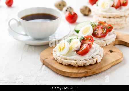 Les sandwiches ouverts de gâteaux de riz au fromage à la crème , légumes et oeuf de caille, petit-déjeuner sain Banque D'Images