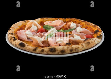 Pizza avec des tomates cerises, fromage, jambon et rucola isolé sur fond noir Banque D'Images