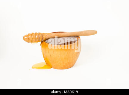 Le miel dans un bol en bois et un type spécial d'une cuillère de miel, le miel d'un balancier. Banque D'Images