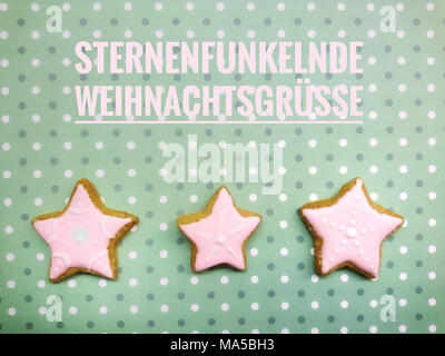 Les Cookies, trois, les étoiles, l'écriture, 'ternenfunkelnde Weihnachtsgrüße', Banque D'Images