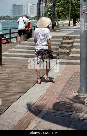 Le port d'un touriste chinois conique traditionnelle 'coolie' hat Banque D'Images