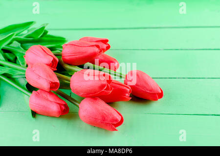 Vue de dessus du beau printemps tulipes rouges bouquet et don avec ruban sur fond de bois vieux Banque D'Images
