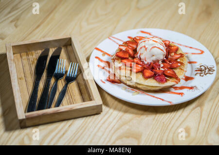 Pain perdu aux glaces et des fraises fraîches avec de la crème à fouetter on white plate Banque D'Images