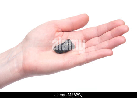 Young woman holding moldavite - forme d'tektite trouvés le long des rives de la rivière Moldau en République tchèque, isolé sur fond blanc Banque D'Images