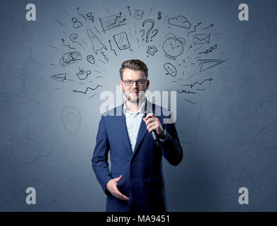 Businessman parlant au micro avec des doodles sur sa tête Banque D'Images