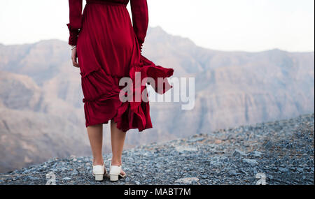 Mode fille en robe rouge sur un désert montagne close up Banque D'Images