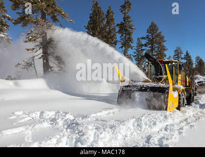 Camion de labour dissiper la neige sur la route après une nuit de tempête d'hiver à Lake Tahoe, California, United States. Banque D'Images