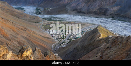 Photos d'une grande hauteur sur le Spiti Valley : près de la rivière il y a un petit village de montagne, les falaises sont éclairées par les rayons du soleil au coucher du soleil, photo Banque D'Images