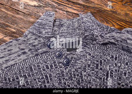 Warm grey melange men's winter sweater on a wooden background Banque D'Images