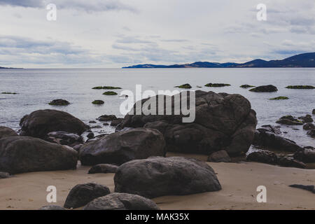 Plage déserte à Hobart, Tasmanie avec des pierres au premier plan sur l'image avec des tons doux légèrement Banque D'Images