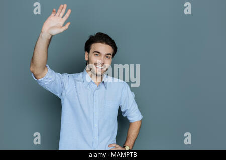 Friendly positive man holding sa main Banque D'Images