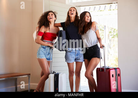 Groupe de femmes amis arrivant à la location de vacances d'été Banque D'Images