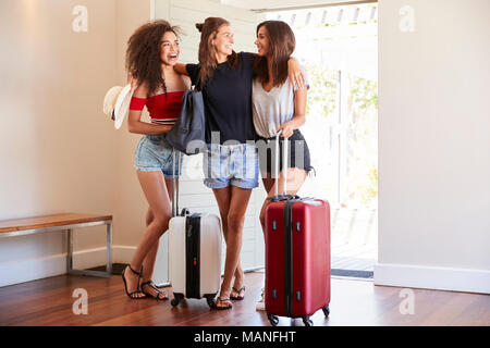 Groupe de femmes amis arrivant à la location de vacances d'été Banque D'Images