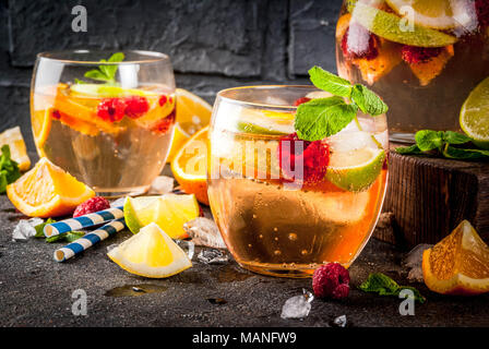 Summer cocktail glacé, fruits et baies de la sangria blanche avec de la pomme, citron, orange et framboise. arrière-plan sombre, copy space Banque D'Images