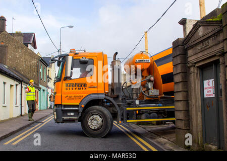 Un ouvrier en Hi Viz habillement donnant des directives au conducteur d'un camion de livraison de béton en vrac lourds dans la ville de Cork en Irlande Banque D'Images