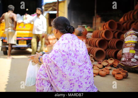 Bangalore, Inde - 15 octobre 2016 : pas de femme assise sur le pavé de la rue de la Poterie, à Bangalore. Banque D'Images