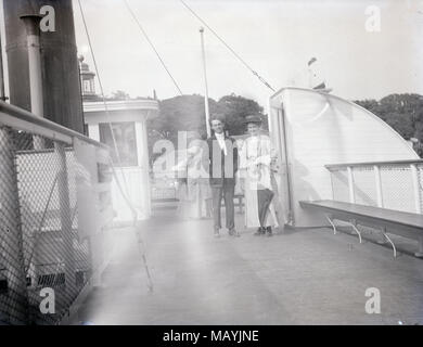 Meubles anciens c1910 photo, deux personnes sur le Bristol Ferry, à bord du navire Bristol, sur la baie de Narragansett, Rhode Island, USA. La salle de bains des femmes est la structure courbe visible à droite. SOURCE : ACÉTATE D'EFFETS NÉGATIFS Banque D'Images