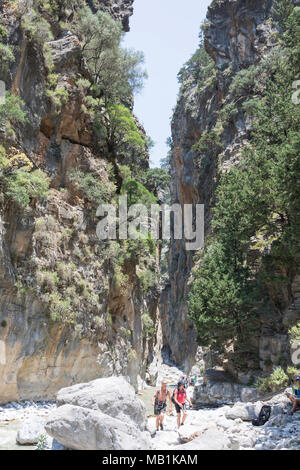 Les promeneurs marchant à travers portes étroites de la Gorge de Samaria. Agia Roumeli, Sfakia, Chania, Crete Région (Crète), Grèce Banque D'Images