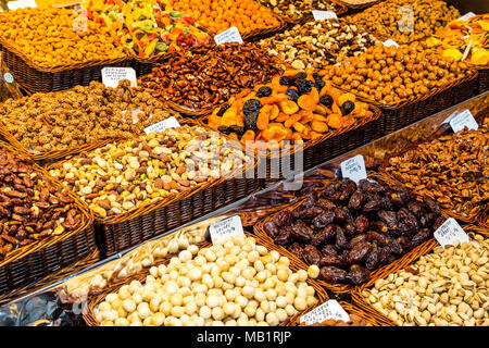 Variété de grains tels que noix, datils, raisins, pistaches, noix de macadamia, prête pour la vente sur le marché de la Boqueria Banque D'Images